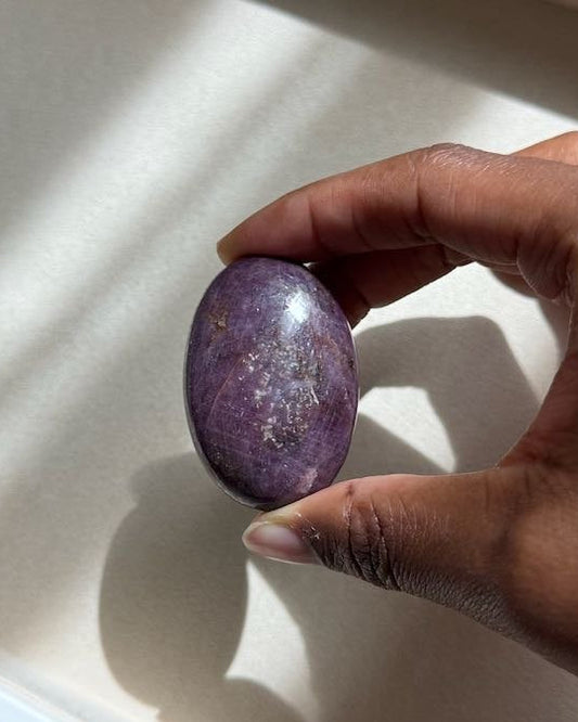 UNSHAKEN ruby palm stone held in hand