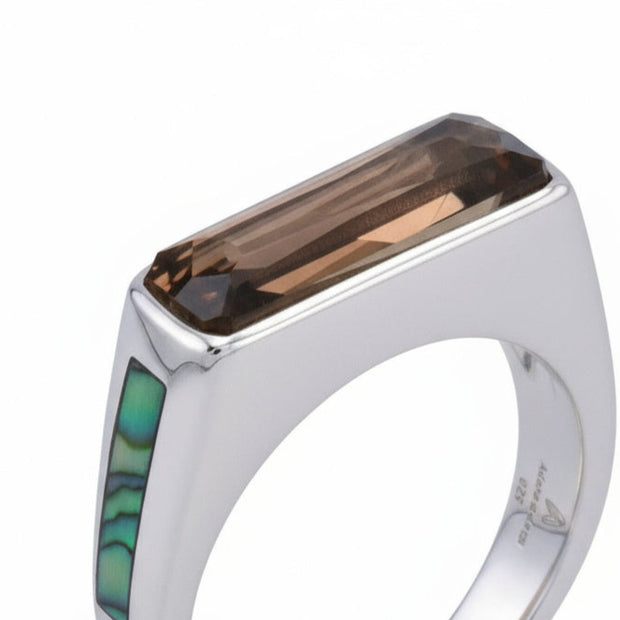 Silver ring with a rectangular brown gemstone and green inlay on a white background