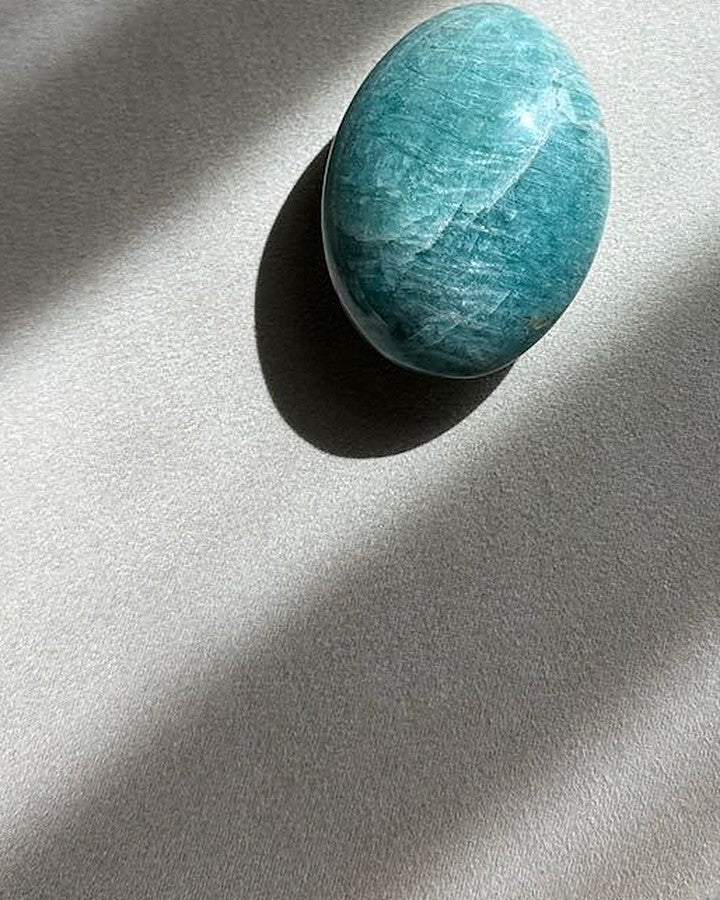 ALIGNED amazonite palm stone on cream tray