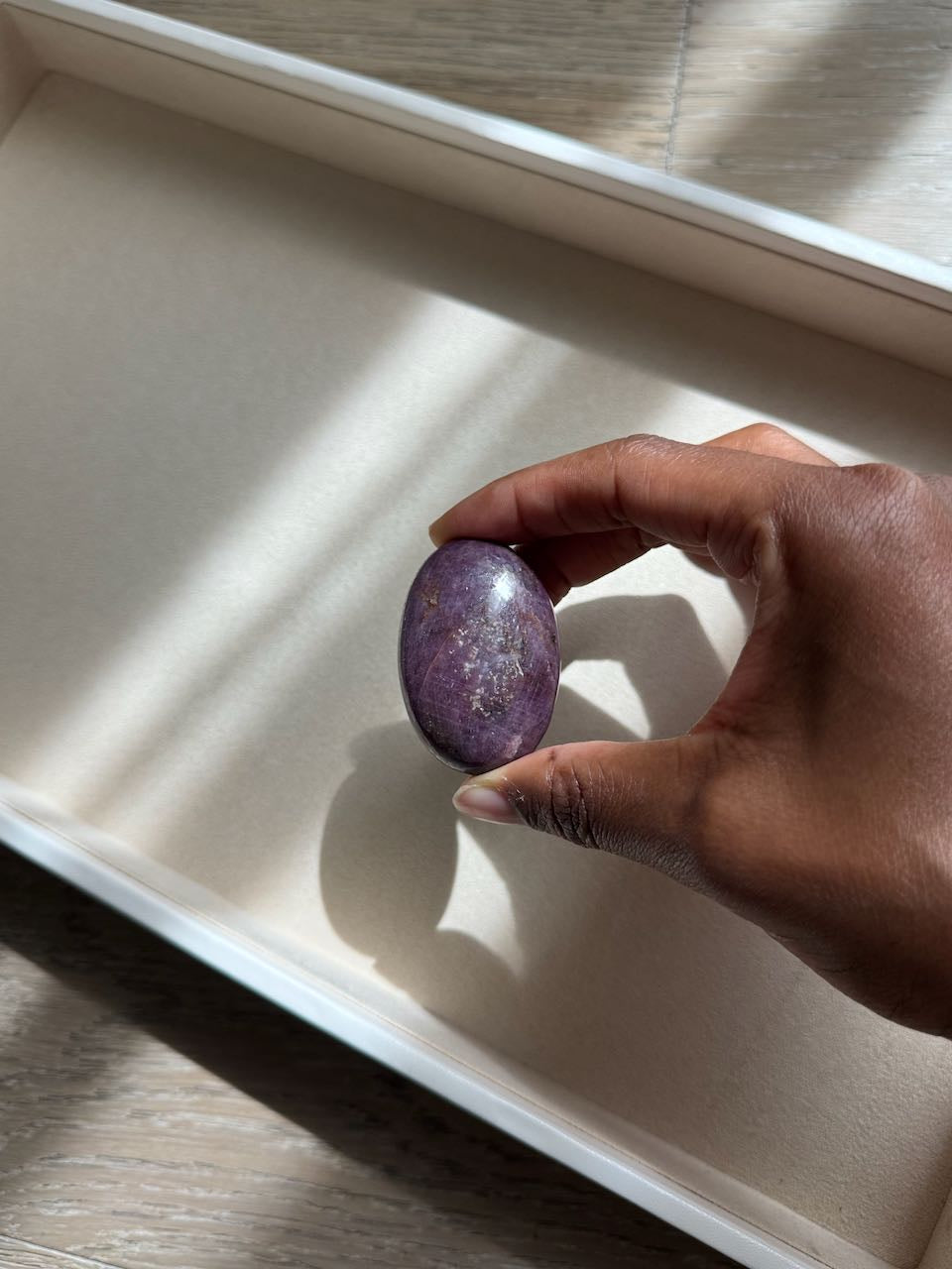 Phosphosiderite palm stone cupped in a hand, showing its scale