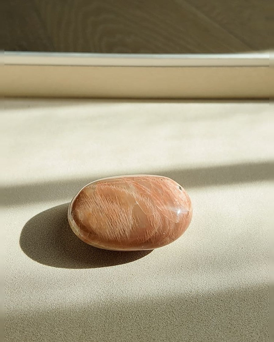 KINDLING peach moonstone palm stone on cream tray