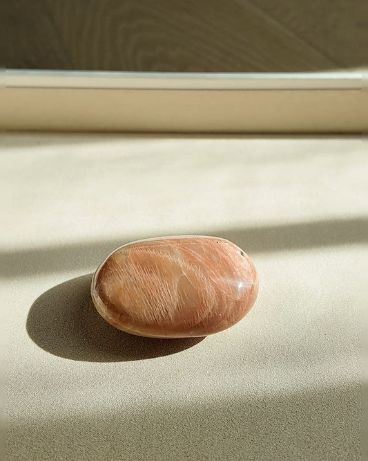 KINDLING peach moonstone palm stone on cream tray