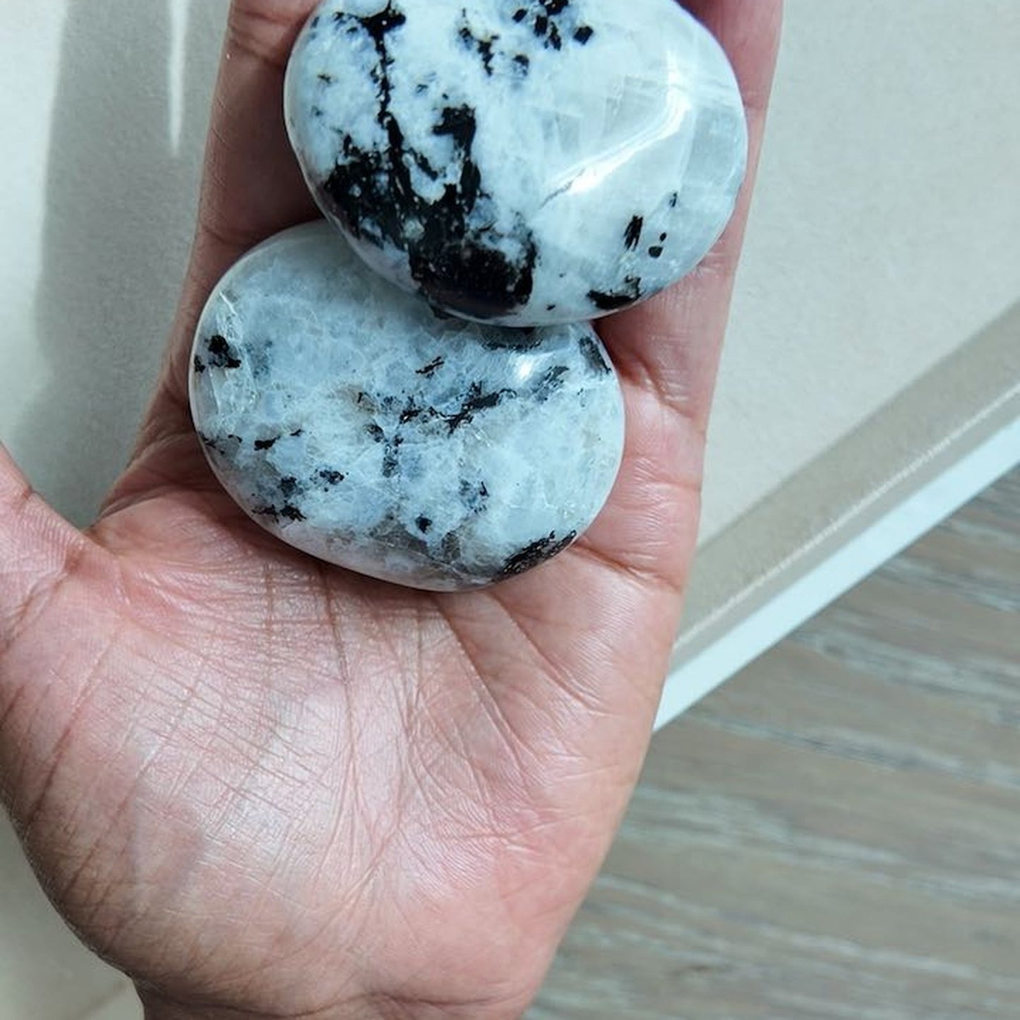 KNOWING rainbow moonstone palm stones held in hand