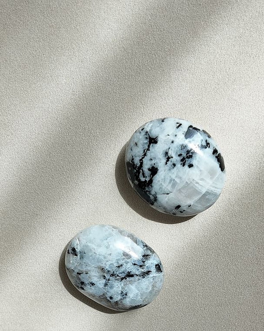 KNOWING rainbow moonstone palm stones on cream tray