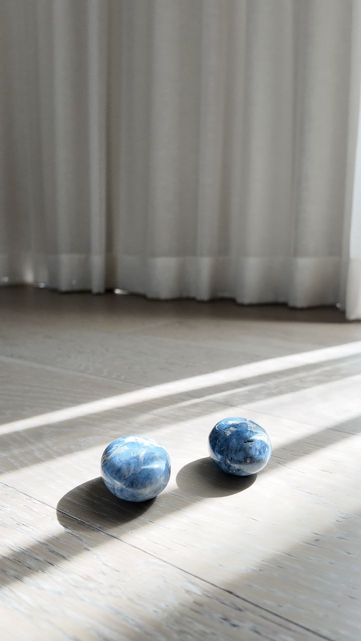 Both blue quartz palm stones together, showing the pair that exists