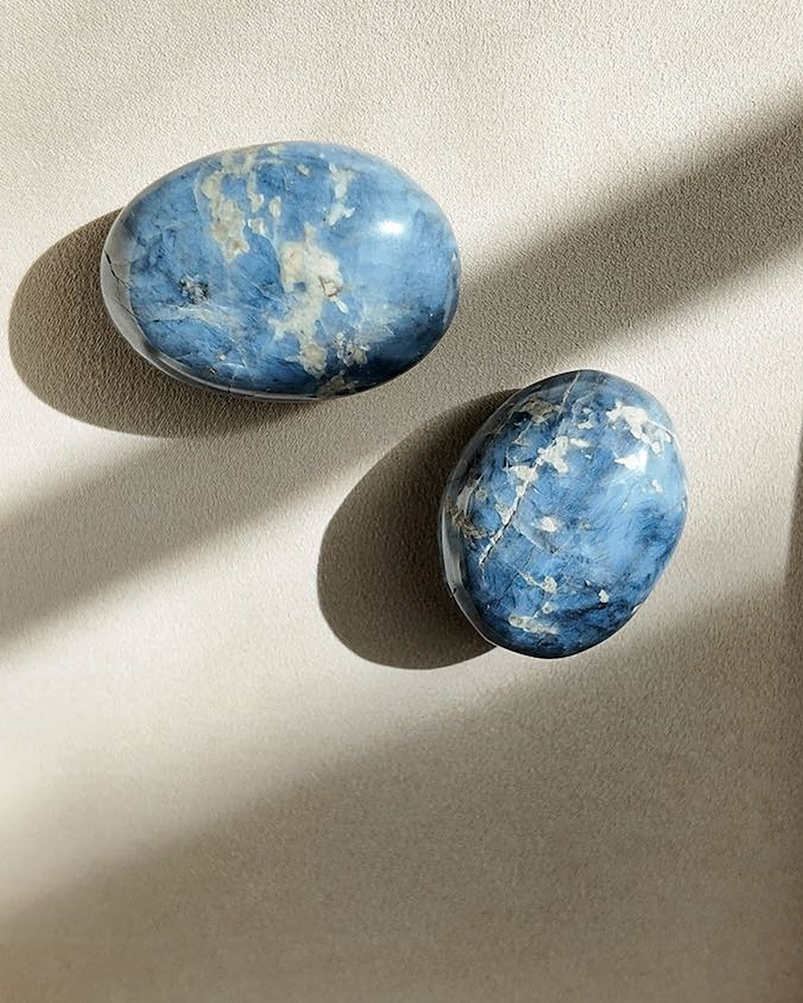 LIT FROM WITHIN blue quartz palm stones on cream tray