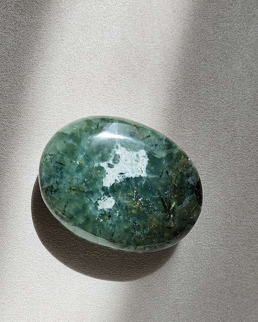 MEND prehnite with epidote palm stone on cream tray