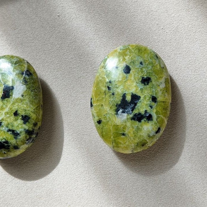 ROOTED lizardite palm stones, the pair