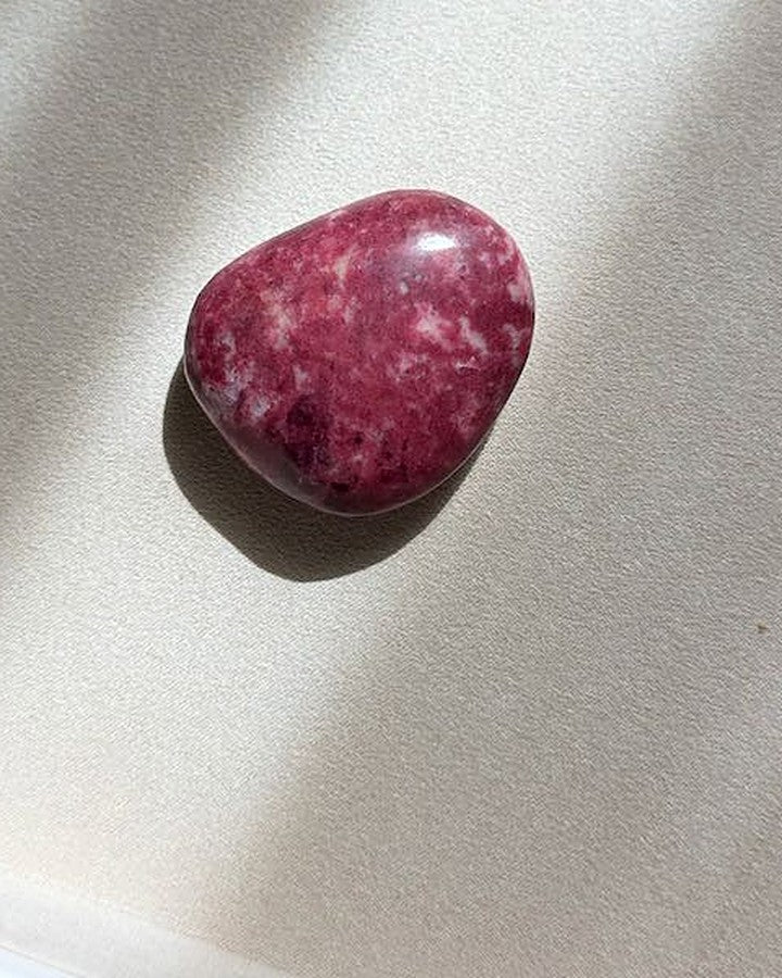 TENDER thulite palm stone on cream tray