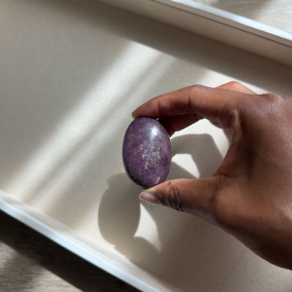 UNSHAKEN ruby palm stone held in hand